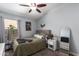 Bright bedroom with a ceiling fan, large window, and neutral decor at 18643 N 73Rd Ave, Glendale, AZ 85308