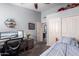 Bright bedroom with a study desk, closet, and hexagon shelves at 18643 N 73Rd Ave, Glendale, AZ 85308