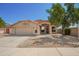 Charming single-story home featuring a well-manicured front yard, desert landscaping, and a two-car garage at 18643 N 73Rd Ave, Glendale, AZ 85308