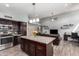 Open concept kitchen and living area with granite island and stainless steel appliances at 18643 N 73Rd Ave, Glendale, AZ 85308