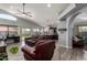 Spacious living room showcases a vaulted ceiling, ceiling fan, and seamless flow to the adjacent kitchen at 18643 N 73Rd Ave, Glendale, AZ 85308