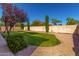 Picture of the grassy backyard with rock landscaping, and brick wall at 1865 S Morrison Ln, Gilbert, AZ 85295