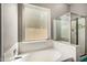 Luxurious bathroom featuring a deep soaking tub and a separate glass-enclosed shower at 1865 S Morrison Ln, Gilbert, AZ 85295