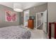 Comfortable bedroom showcasing a dresser and an adjacent bathroom; bright tapestry included at 1865 S Morrison Ln, Gilbert, AZ 85295