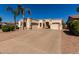 Single-story home featuring a three-car garage and mature landscaping at 1865 S Morrison Ln, Gilbert, AZ 85295