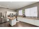 Well-lit kitchen with white cabinetry, stainless steel appliances, and granite countertops on island at 1865 S Morrison Ln, Gilbert, AZ 85295