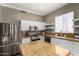 Spacious kitchen with granite countertops, stainless steel appliances, and island, great for cooking at 1865 S Morrison Ln, Gilbert, AZ 85295