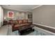 Bright living room featuring a leather sofa and stylish decor at 1865 S Morrison Ln, Gilbert, AZ 85295