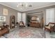 Cozy living room featuring stylish decor, surfboard accent, and a large vibrant rug at 1865 S Morrison Ln, Gilbert, AZ 85295