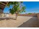 Backyard with tree, fence, gravel, and brick building at 1919 W Fairmount Ave, Phoenix, AZ 85015