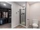 Bathroom featuring a tiled shower with glass door and a door leading to walk-in closet at 1919 W Fairmount Ave, Phoenix, AZ 85015