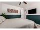 Spacious bedroom with updated wall decor, plush carpeting, ceiling fan, and ample natural light at 1919 W Fairmount Ave, Phoenix, AZ 85015