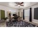 Creative room featuring sound-dampening, wooden desk, a comfortable office chair, and a ceiling fan at 1919 W Fairmount Ave, Phoenix, AZ 85015