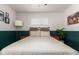 Well-lit bedroom featuring two-tone gray and dark green walls, plush carpet, and a ceiling fan at 1919 W Fairmount Ave, Phoenix, AZ 85015