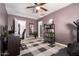 Bedroom with a ceiling fan, shelves with plants, desk, and a gray couch at 1919 W Fairmount Ave, Phoenix, AZ 85015