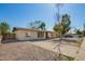 Inviting single-story home featuring a neutral color scheme, long driveway, and xeriscaped yard at 1919 W Fairmount Ave, Phoenix, AZ 85015