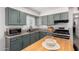 Updated kitchen featuring ample cabinet space, granite counters, stainless appliances, and an island with butcher block top at 1919 W Fairmount Ave, Phoenix, AZ 85015