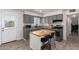 Stylish kitchen features modern gray cabinets, stainless appliances, granite countertops, and an island with seating at 1919 W Fairmount Ave, Phoenix, AZ 85015