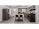 Bright kitchen with stainless appliances, center island with seating, and gray cabinets at 1919 W Fairmount Ave, Phoenix, AZ 85015