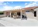 Spacious backyard patio featuring overhead structure and ample seating for outdoor entertaining at 20473 N Desert Sage Ln, Surprise, AZ 85374