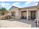 Covered front patio with seating area, providing a relaxing outdoor space with desert landscaping at 20473 N Desert Sage Ln, Surprise, AZ 85374