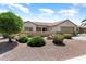 Beautiful single-story home with desert landscaping, manicured shrubs, and a two-car garage at 20473 N Desert Sage Ln, Surprise, AZ 85374