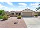 Charming single-story home featuring a well-maintained yard and a two-car garage at 20473 N Desert Sage Ln, Surprise, AZ 85374