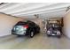 Spacious two-car garage featuring an electric vehicle and a golf cart at 20473 N Desert Sage Ln, Surprise, AZ 85374