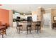 Well-lit kitchen with white cabinets, black appliances, and breakfast bar seating at 20473 N Desert Sage Ln, Surprise, AZ 85374