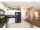 Modern kitchen with granite counters, black appliances, and bright white cabinetry at 20473 N Desert Sage Ln, Surprise, AZ 85374