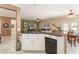 Open kitchen features granite countertops and seamlessly connects to the living and dining areas at 20473 N Desert Sage Ln, Surprise, AZ 85374