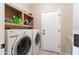 Convenient laundry room with modern washer and dryer units and overhead storage at 20473 N Desert Sage Ln, Surprise, AZ 85374