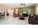Open-concept living room with tile flooring, cozy seating, and natural light at 20473 N Desert Sage Ln, Surprise, AZ 85374