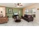 Comfortable living room featuring tile floors, a ceiling fan, and neutral décor at 20473 N Desert Sage Ln, Surprise, AZ 85374