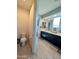 A bathroom featuring tile flooring, a black vanity, natural light, and a toilet at 22026 N 28Th Pl, Phoenix, AZ 85050