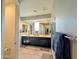 A bathroom with dual sinks, a large mirror, a shower, and tile flooring at 22026 N 28Th Pl, Phoenix, AZ 85050