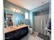 A bathroom features blue walls, a shower, and a black vanity at 22026 N 28Th Pl, Phoenix, AZ 85050