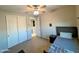 Bright bedroom featuring a ceiling fan, closet, and a cozy bed, creating an inviting space at 22026 N 28Th Pl, Phoenix, AZ 85050