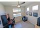 Modern bedroom with stylish gray walls, ceiling fan, and large windows allowing natural light at 22026 N 28Th Pl, Phoenix, AZ 85050
