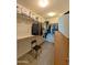 A walk-in closet features metal shelving, carpet, and a black chair at 22026 N 28Th Pl, Phoenix, AZ 85050