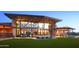 Modern clubhouse with expansive windows, outdoor seating, and a cozy fire pit area at 22026 N 28Th Pl, Phoenix, AZ 85050
