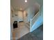 Inviting foyer features neutral tile flooring, a coat rack, and a staircase with white railing at 22026 N 28Th Pl, Phoenix, AZ 85050