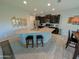 Modern kitchen island with granite counters and dark cabinets provides both seating and counterspace at 22026 N 28Th Pl, Phoenix, AZ 85050