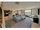 Open-concept living room flows into the kitchen, featuring plush carpeting and a comfortable gray sofa at 22026 N 28Th Pl, Phoenix, AZ 85050