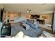 Spacious living area with a large gray sectional couch that opens to the kitchen at 22026 N 28Th Pl, Phoenix, AZ 85050