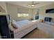 This carpeted main bedroom features a walk-in bathroom and a ceiling fan with neutral walls and natural light at 22026 N 28Th Pl, Phoenix, AZ 85050