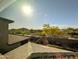 An outside view from the window displays a beautiful mountain, neighboring roofs, and lush trees under the sun at 22026 N 28Th Pl, Phoenix, AZ 85050