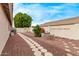 Backyard with brick border, decorative stone pathway, and mature shade tree at 2233 S Nielson St, Gilbert, AZ 85295