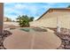 An in-ground pool is fenced in and bordered by rock landscaping and low-maintenance plants at 2233 S Nielson St, Gilbert, AZ 85295