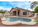 A fenced backyard featuring an in-ground pool surrounded by well-kept landscaping at 2233 S Nielson St, Gilbert, AZ 85295